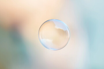 translucent bubble suspended in the air against a soft, pastel background. 