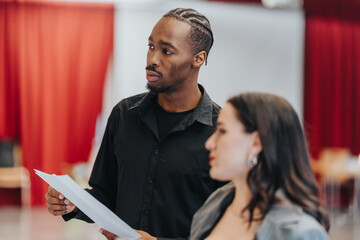 Focused individuals reviewing paperwork during a collaborative meeting, demonstrating teamwork and analytical skills within a professional environment.