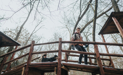 A group of friends spending quality time outdoors in a scenic snowy forest, exploring and enjoying...