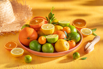 Fresh mix of citrus fruits on rustic yellow table