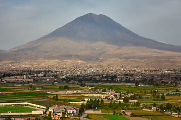 As the sun sinks behind the Andes, Areequipa-the White City glows in soft amber light,framed by the...