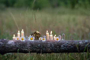 moon amulet, quartz crystals, flowers and burning candles outdoor, natural background. Witchcraft, Esoteric spiritual practice. magic Ritual for life balance, cleansing aura, soul calming.