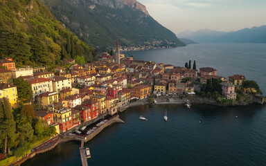 Obraz premium Panoramic aerial view of Varenna during sunset, famous picturesque old town and turistic destination in Lake Como, Lecco Province, Lombardy, Italy. Captured by drone. 