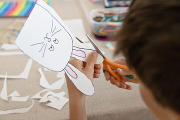 A child carefully cuts out his or her bunny, practicing fine motor skills, scissor control, and...