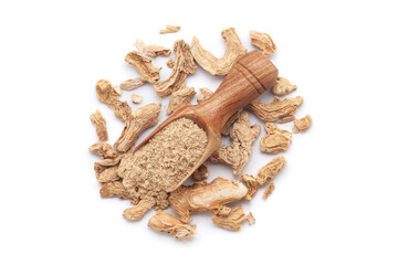 A wooden scoop filled with organic dry Ginger root (Zingiber officinale) or sonth powder, placed on a heap of ginger roots, isolated on a white background.