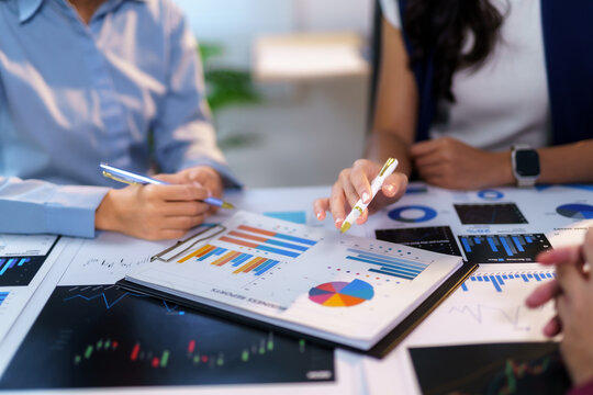 Business team analyzing financial data and planning new marketing strategy using charts and graphs showing market growth