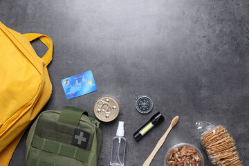 Survival kit. Different emergency supplies on grey table, flat lay. Space for text