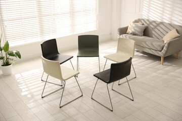 Chairs in circle prepared for group psychotherapy session indoors