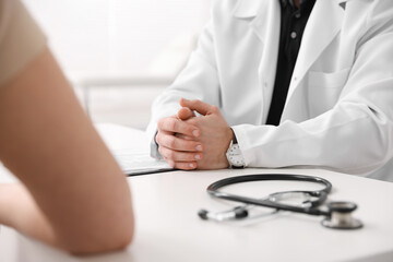 Fototapeta premium Woman having appointment with doctor in hospital, closeup