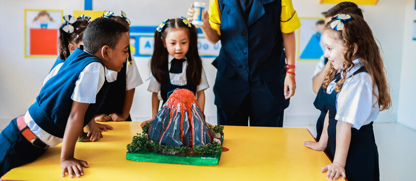 School, Group of children in science class learn about volcanos at kindergarten class room. Education concept