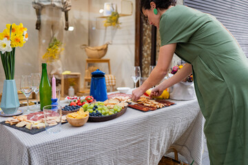 Elegant buffet setup with flowers, fruits, and meats