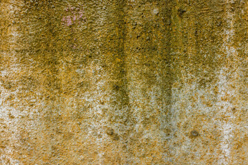 rough concrete wall with yellow stains