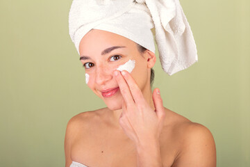 Woman Enjoying Skincare Routine with Cream and Towel