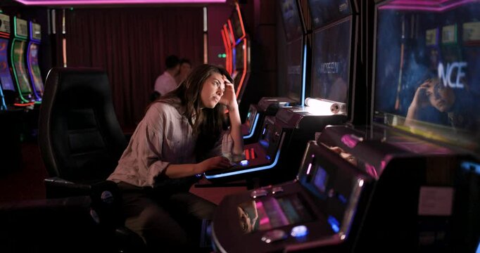 Woman Bored and Disappointed at Slot Machine in Casino