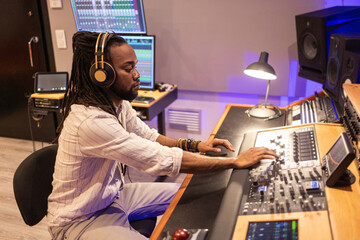 Audio Engineer Mixing Tracks in Modern Recording Studio