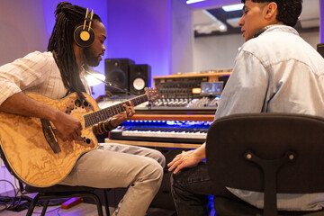 Recording studio session with guitar and sound engineer