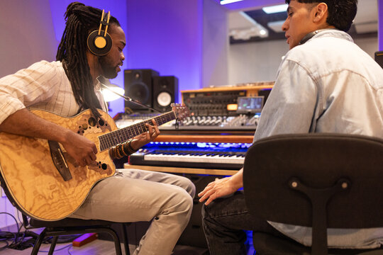 Recording studio session with guitar and sound engineer