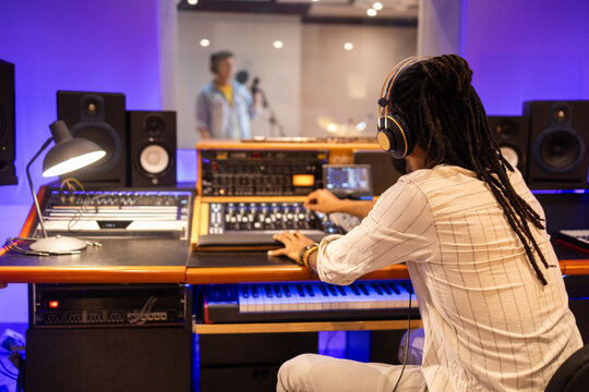 Audio engineer working in a professional recording studio setup