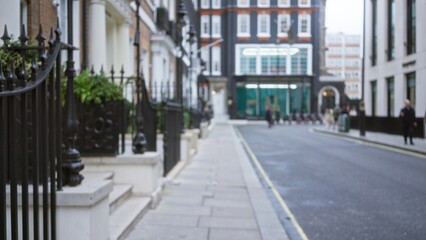 Fototapeta premium Blurred city street scene in london during winter with defocused architecture, highlighting a classic british urban atmosphere with a soft bokeh effect.