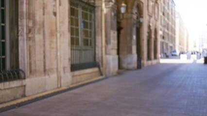 Blurred image of an outdoor street scene in marseilles, france with a bokeh effect, showcasing defocused architecture and european urban charm.