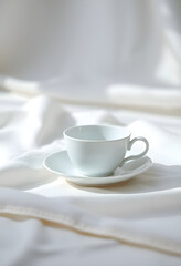 Fototapeta premium white cup sitting on top of a saucer