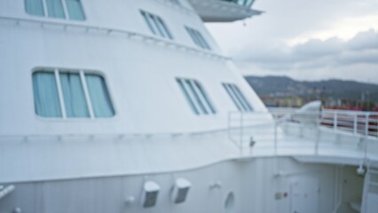 Blurred ship with bokeh background and defocused cargo at port creates abstract maritime impression.