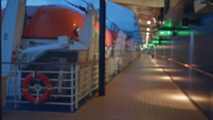 Blurred view of a cruise ship deck with lifeboats under twilight sky, capturing serene, defocused clarity and ambient, tranquil atmosphere for a dreamy nautical setting.