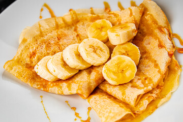 Crepes sweet banana syrup pancakes breakfast dish dessert organic product fresh tasty gourmet food background on the table rustic food top view copy space