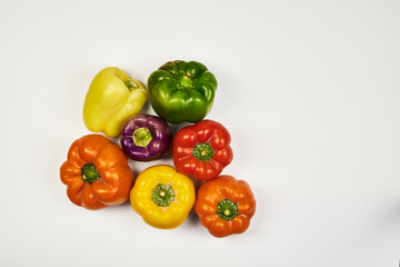 Diverse and colorful variety of bell peppers found naturally in the regions of Peru displayed on a white background