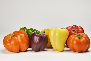 Diverse and colorful variety of bell peppers found naturally in the regions of Peru displayed on a white background
