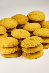 A group of sugar cookies are neatly stacked on top of each other on a white background..Close-up