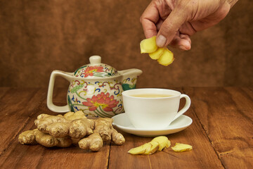 Ginger root infusion served in a teacup to combat the cold as a natural antibiotic