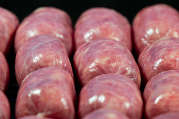 Raw Sausages Background on a Frying Pan. Process of Preparing Tasty Hotdogs. Unhealthy Food. Meat for Grill Barbeque
