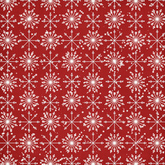 Seamless red Christmas pattern with white snowflakes and falling snow, festive winter background perfect for wrapping paper, fabric, gift packaging, scrapbooking and holiday decor.