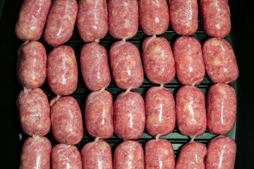 Raw Sausages Background on a Frying Pan. Process of Preparing Tasty Hotdogs. Unhealthy Food. Meat for Grill Barbeque