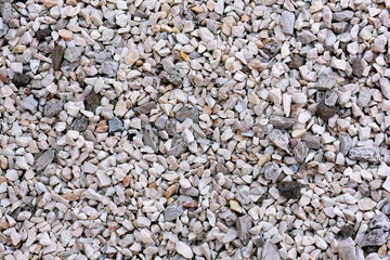Crushed gravel stones forming textured ground surface
