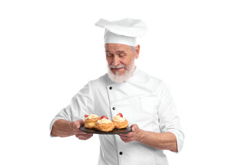 Professional pastry chef with delicious profiteroles on white background