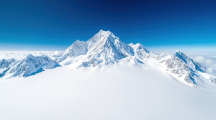 Obraz premium A stunning aerial view of a majestic snow-capped peak rising above a serene sea of clouds, highlighting the beauty and grandeur of untouched nature and mountainous landscapes.