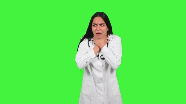 Latin Doctor suffering throat pain on green screen