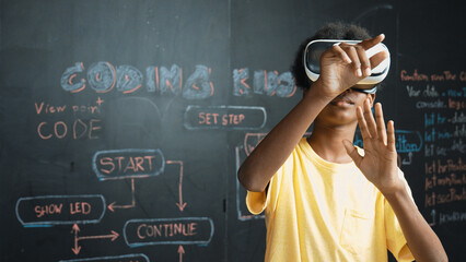African student use VR headset learning innovation at metaverse while standing at blackboard with...