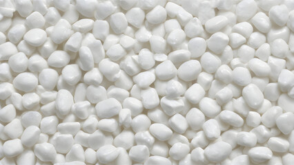 Small white industrial plastic pellets forming a uniform texture