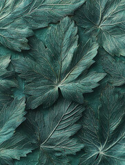 A close-up of a textured surface covered in deeply-veined stylized leaves all rendered in shades of teal and gray.