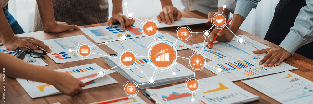 Fototapete A dynamic team collaborates around a table covered with charts and graphs, focusing on marketing strategies and data analysis in a modern office environment. Amity