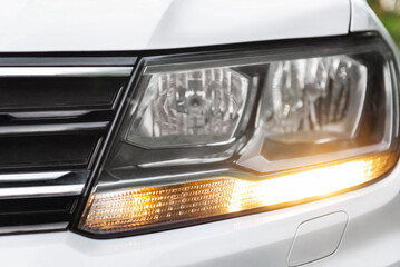 Modern car white headlight close up