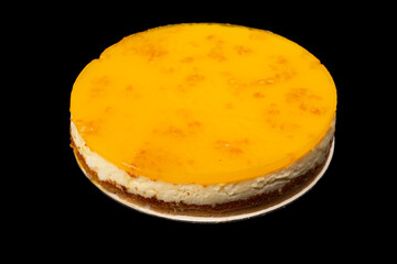 Orange cheesecake isolated on a white background.