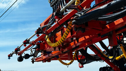 Spraying system close-up on a modern agricultural sprayer, with visible fertilizer nozzles and piping.
