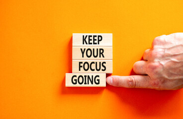 Keep your focus going symbol. Concept words Keep your focus going on beautiful wooden blocks. Beautiful orange table orange background. Business and keep your focus going concept. Copy space.