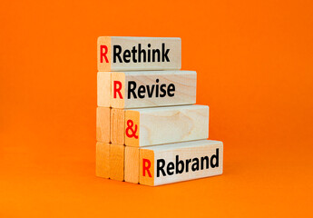 Rethink revise rebrand symbol. Concept word Rethink Revise and Rebrand on beautiful wooden blocks. Beautiful orange background. Business brand rethink revise rebrand concept. Copy space.