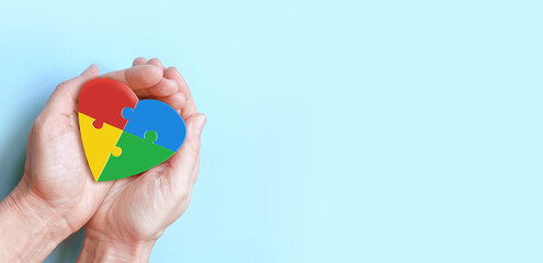 hands holding colorful heart