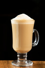 Coffee latte glass cup on wooden table